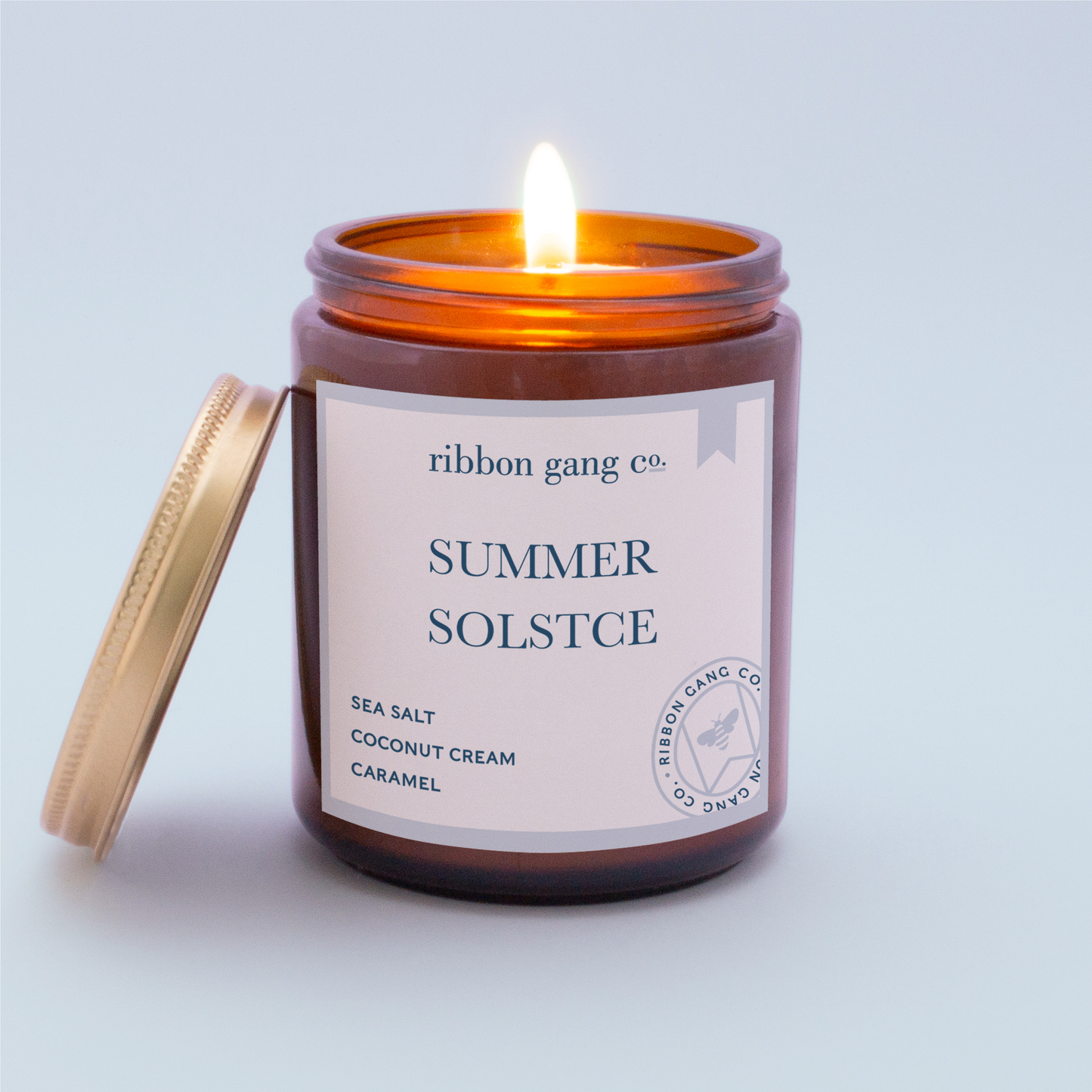 Summer Solstice Candle burning in an amber jar.