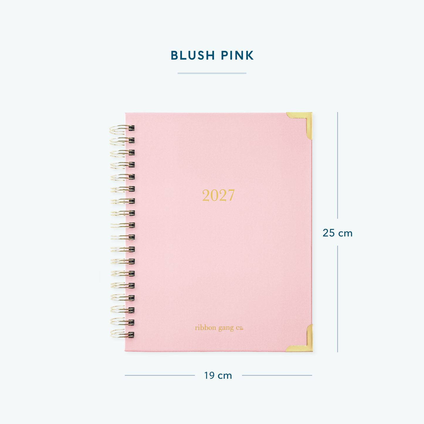 A blush pink spiral bound 2027 planner with gold lettering and gold corners on a white background showing dimensions of 25 cm high and 19 cm wide.