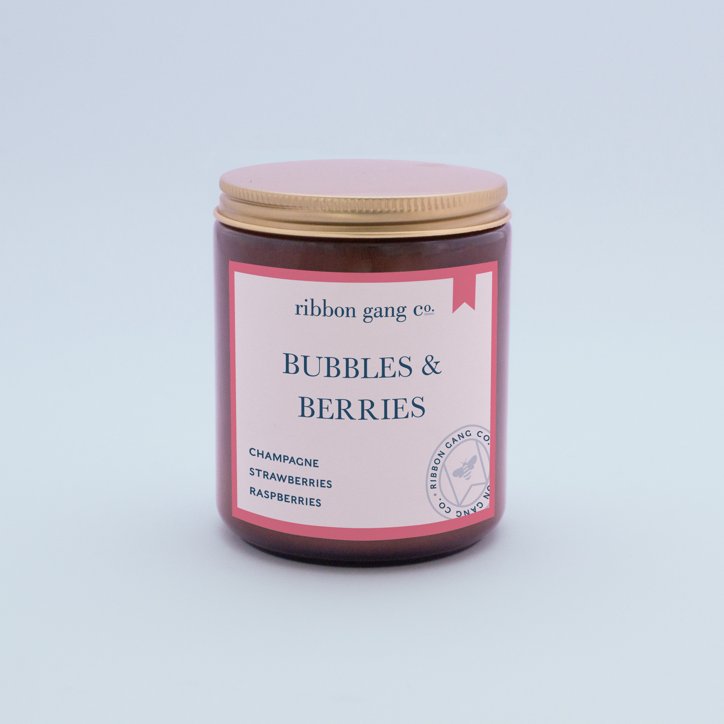 Bubbles & Berries Candle in an amber jar with a gold lid