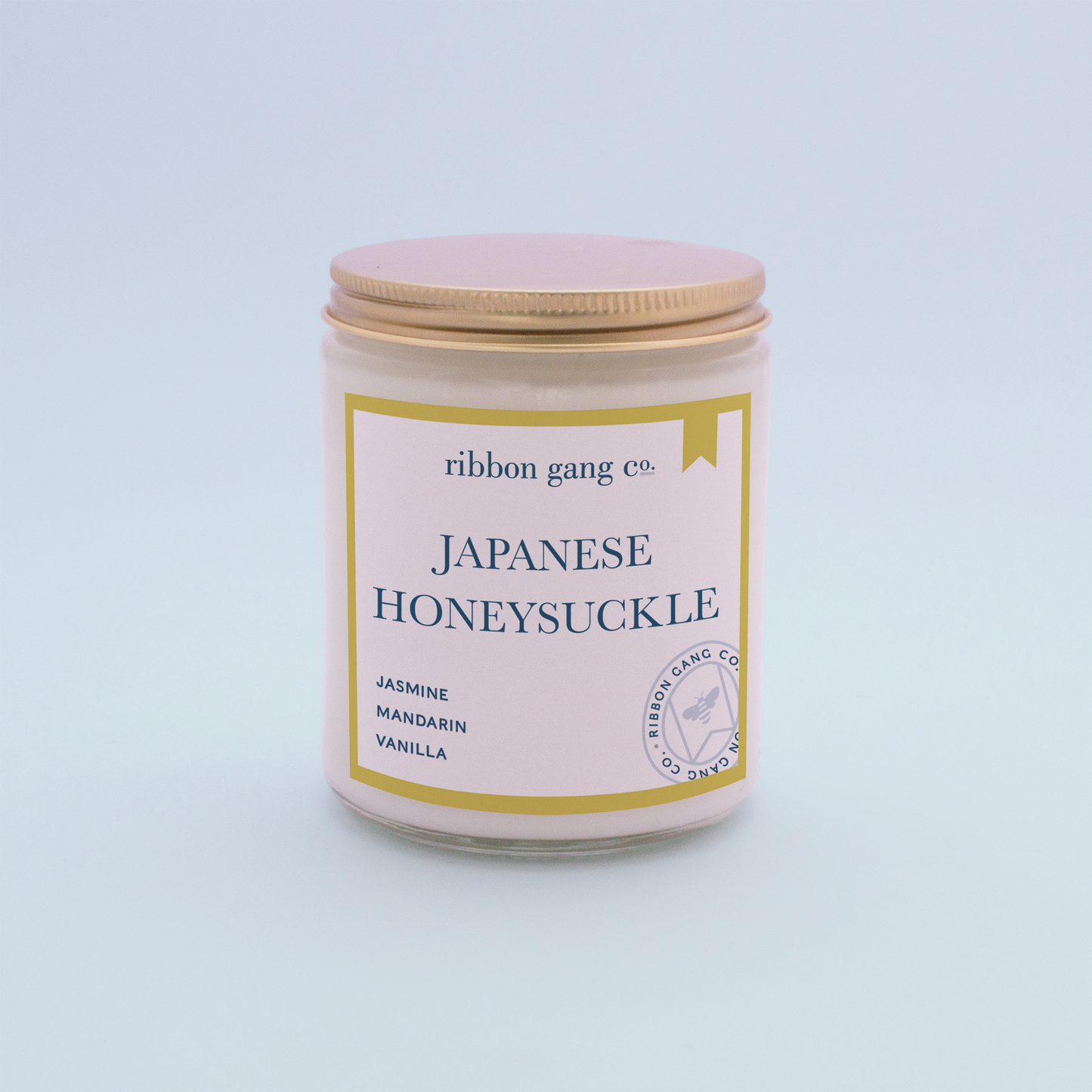 Japanese Honeysuckle Candle in a clear jar with a gold lid