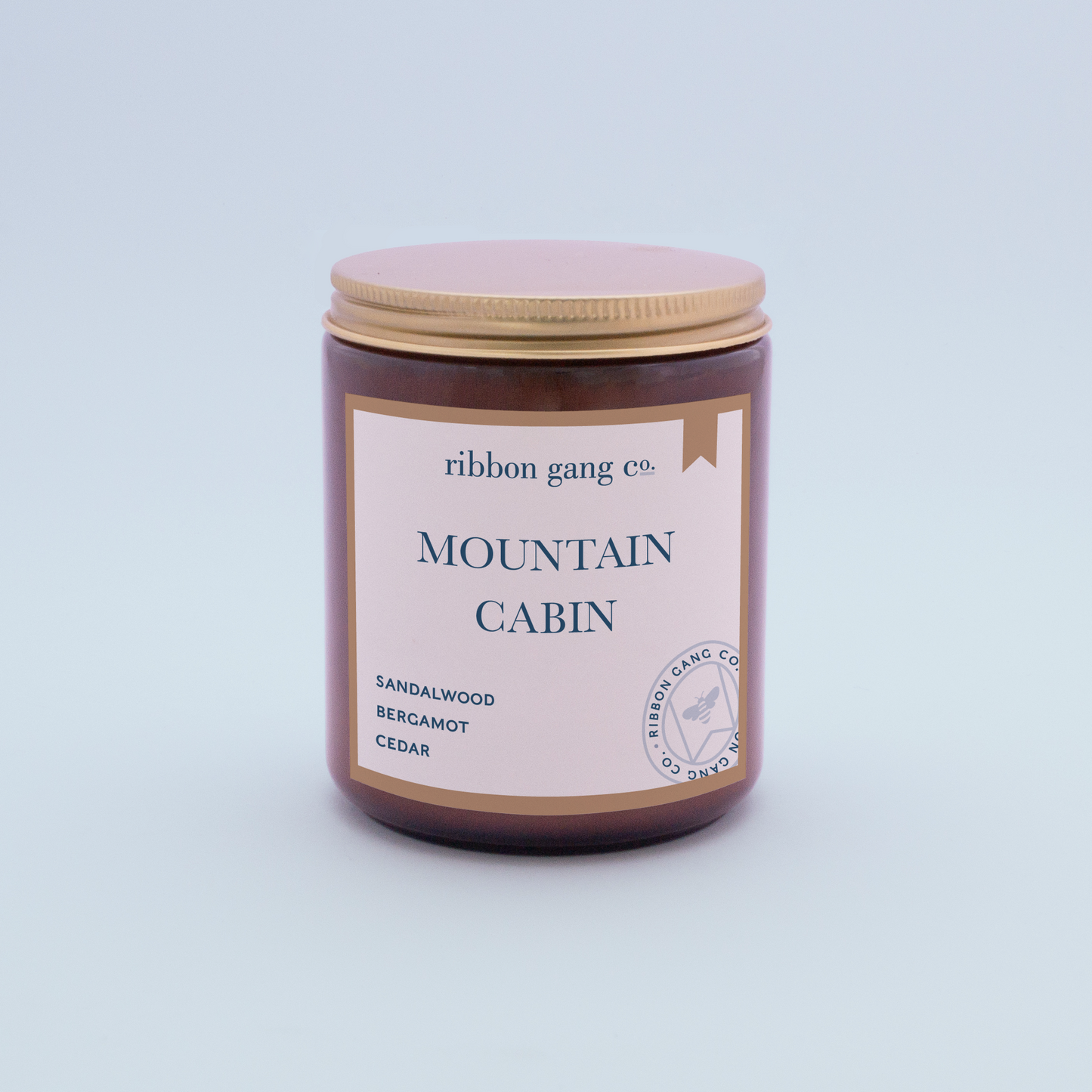 Mountain Cabin Candle in an amber jar with a gold lid