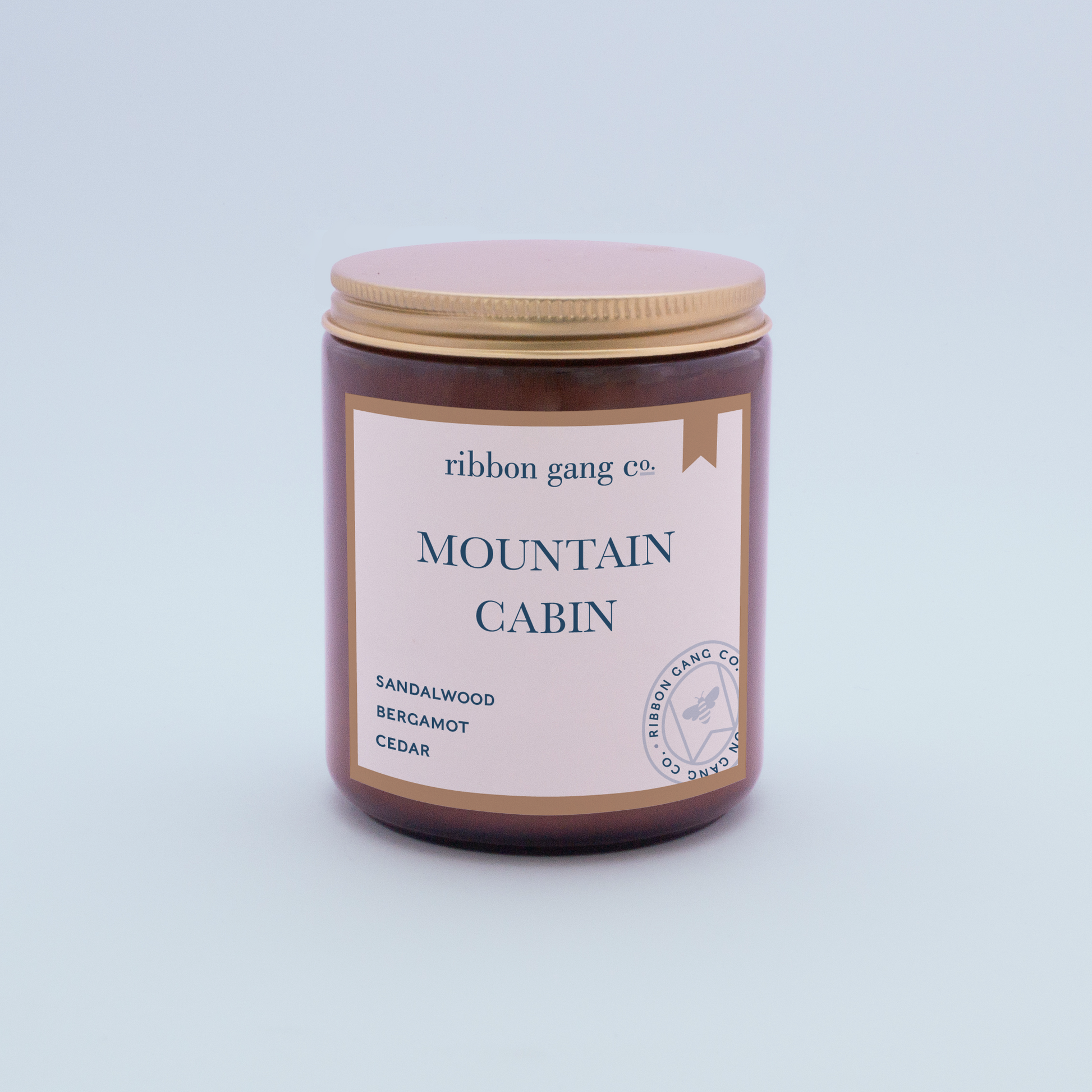 Mountain Cabin Candle in an amber jar with a gold lid