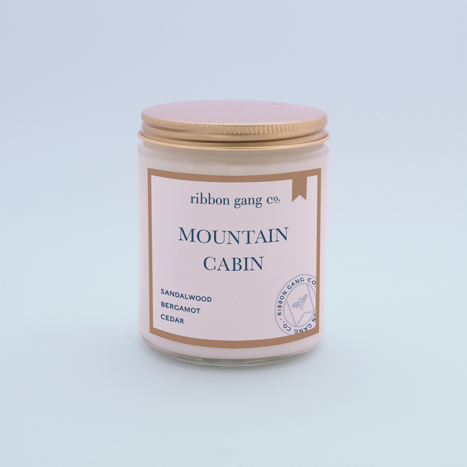 Mountain Cabin Candle in a clear jar with a gold lid