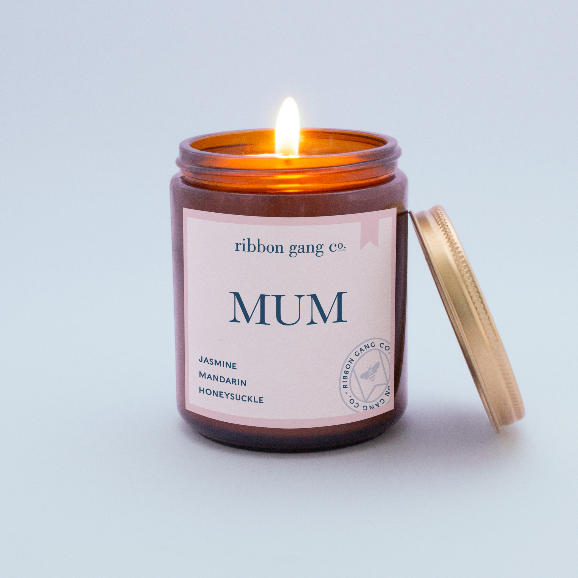 Mum Candle in an amber jar burning