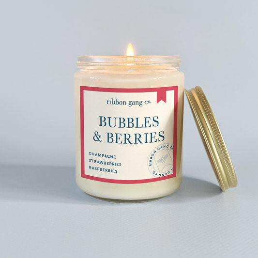Candle with 'Bubbles & Berries' label on a grey background.