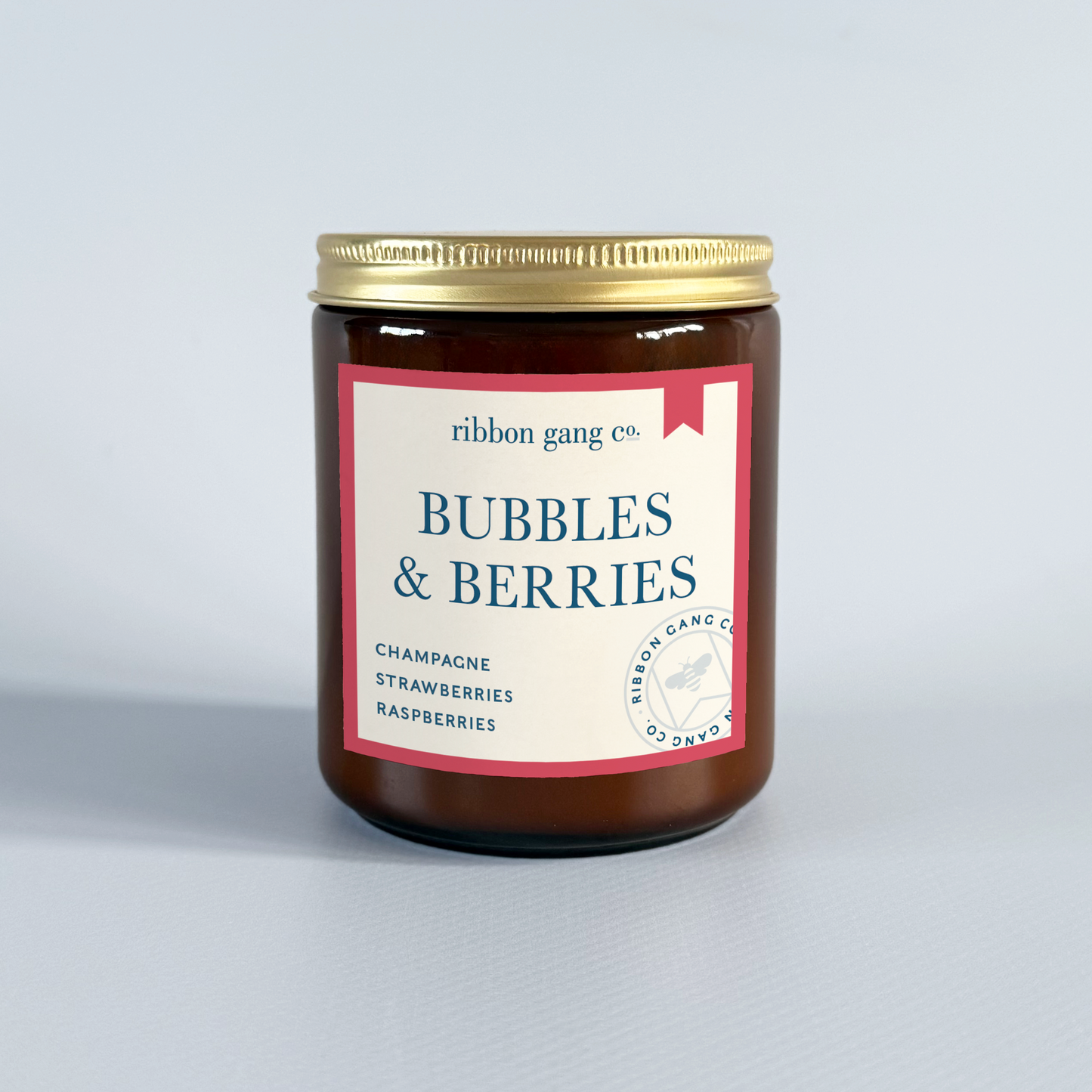 Jar of 'Bubbles & Berries' candle by Ribbon Gang Co. on a light grey background.