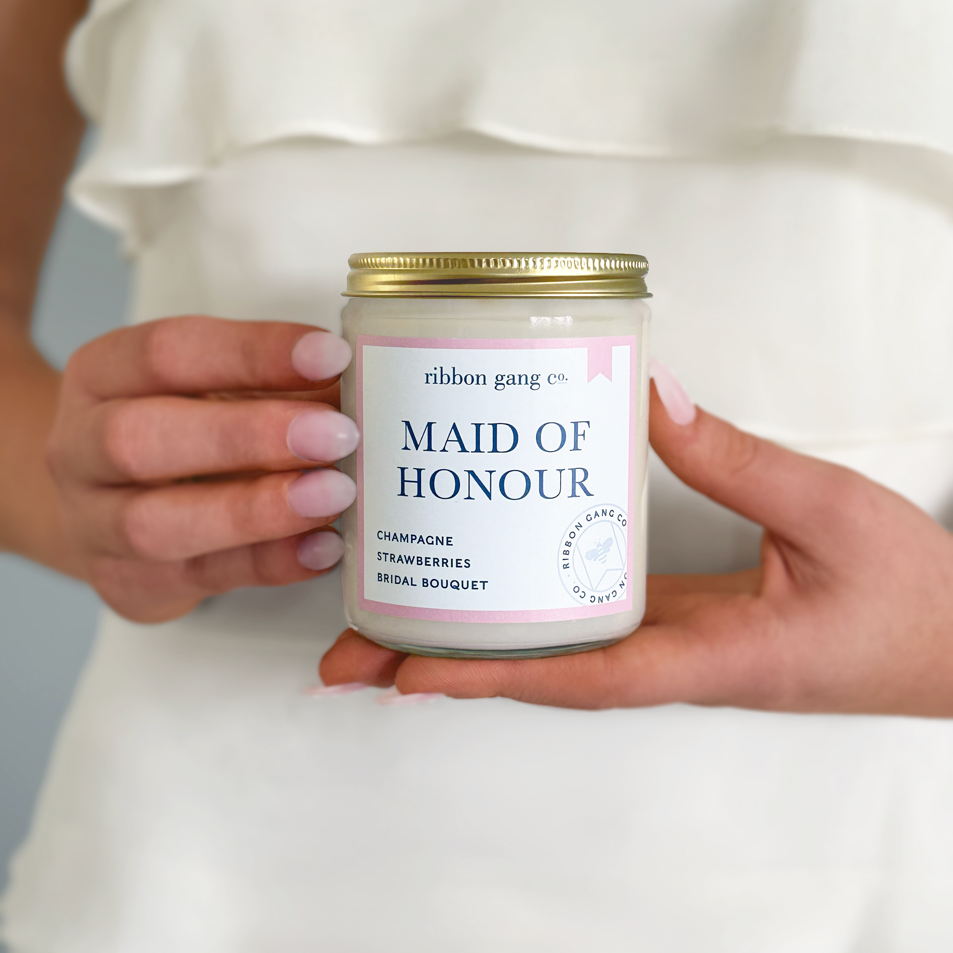 Jar labeled 'Maid of Honour' held by a person in a white dress.